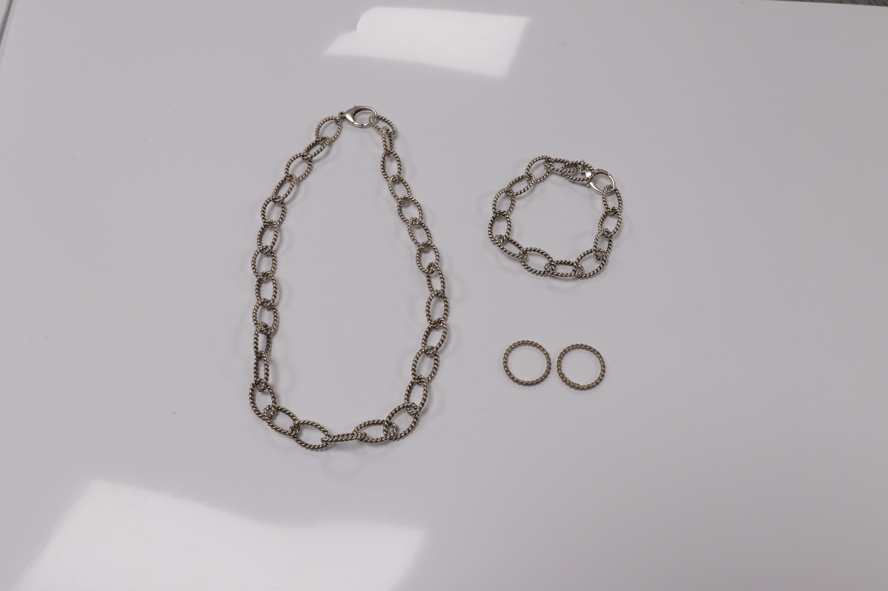 A modern Italian Tiffany & Co 925 suite of jewellery, of rope twist design, comprising a necklace, 42cm, bracelet, 18cm and two rings, size O/P and O. Condition - fair to good